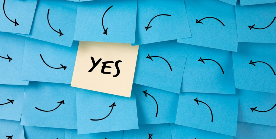 post it notes pointing arrows at the word yes
