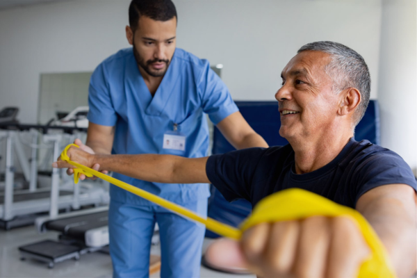 male physio helping male client with hand