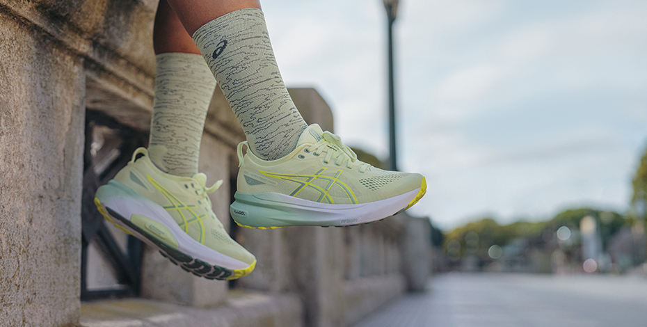 feet hanging off the wall wearing runners