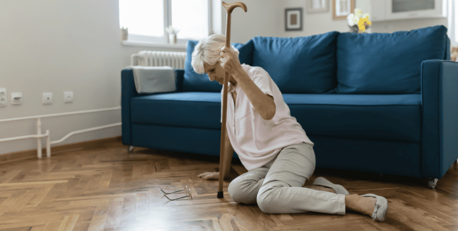Older woman on the floor struggles to get up after a fall